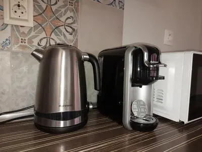 a coffee pot sitting on a counter next to a microwave at Masada in Burgas City