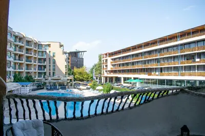 a balcony of a hotel with a pool and buildings at Hotel Grenada in Sunny Beach