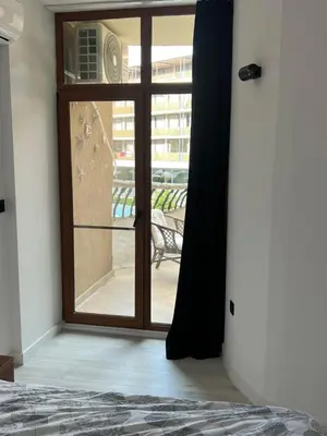 a bedroom with a door open to a balcony at Hotel Grenada in Sunny Beach