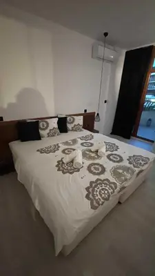 a bedroom with a large bed with white sheets and pillows at Hotel Grenada in Sunny Beach