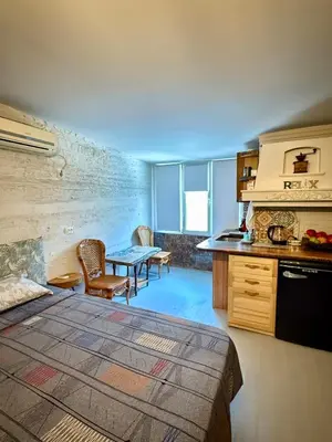 a room with a bed and a kitchen with a table at Art Lux Studio 1 in Burgas City