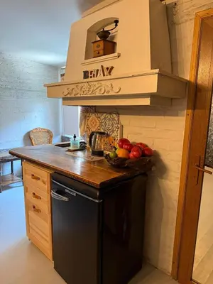 a kitchen with a black refrigerator and a bowl of fruit at Art Lux Studio 1 in Burgas City