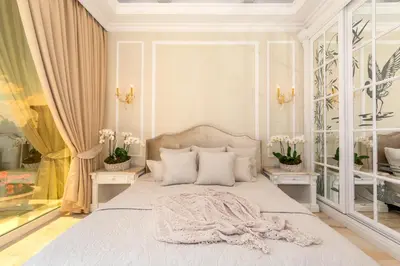 a bedroom with a bed and two tables with flowers at Villa Dolce Vita in Sunny Beach