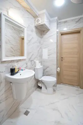 a white bathroom with a toilet and a sink at Marea Garden, Ravda - 1BD Apartment with Pool by Flat Mаnager in Ravda