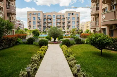 a walkway through a garden in a apartment complex at Marea Garden, Ravda - 1BD Apartment with Pool by Flat Mаnager in Ravda