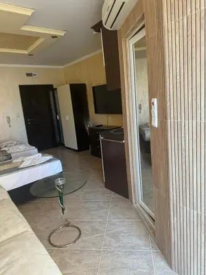 a room with a glass table in the middle of a room at Residensia Bahami in Sunny Beach