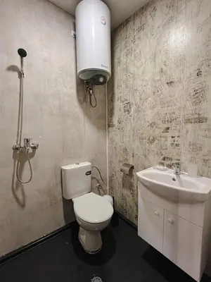 a bathroom with a toilet and a sink at Къмпинг- бунгала Албатрос in Varna City
