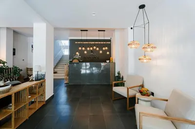 a living room with a staircase and a lobby at Hotel Sozopol 99 in Sozopol