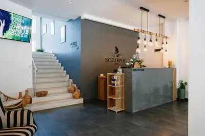 a lobby of a store with stairs and a sign at Hotel Sozopol 99 in Sozopol