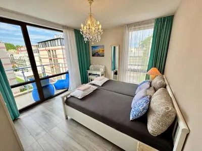 a bedroom with a bed and a large window at Apartment B48 in Tarsis Club Complex in Sunny Beach