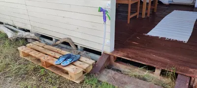 a pair of blue shoes sitting on a wooden bench at Яката Каравана in Kiten