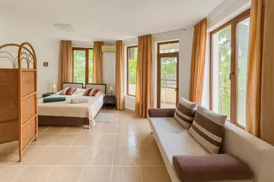 a living room with a bed and a couch at Antonia Seaside Comfort in Sveti Vlas