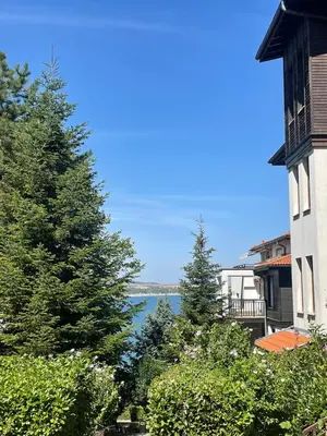 a view of the water from a house with trees at Apartment at the Seaside in Sozopol
