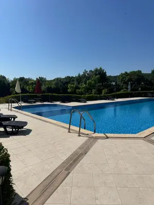 a large swimming pool with a picnic table next to it at Relaxing studio in Shartrez in Shkorpilovtsi