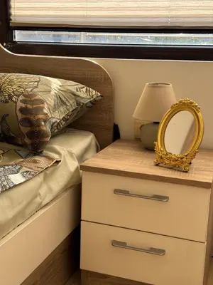 a bedroom with a bed with a mirror and a nightstand at Downtown Harmony Chill Place in Varna City