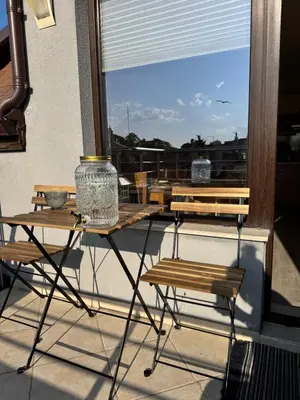 a balcony with a table and chairs and a window at Downtown Harmony Chill Place in Varna City