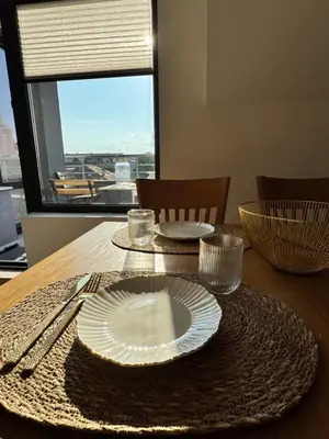 a wooden table with plates and utensils on it at Downtown Harmony Chill Place in Varna City
