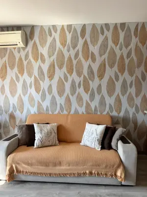 a couch in a living room with a wall at Downtown Harmony Chill Place in Varna City