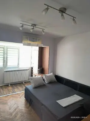 a bedroom with a large black bed with two pillows at Accommodation apartment MARGARITA in Burgas City