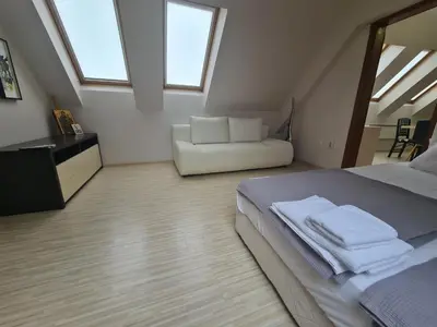 a bedroom with a bed and a white couch at 