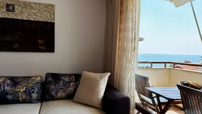a living room with a couch and a view of the ocean at Garden of Eden K 518 in Sveti Vlas