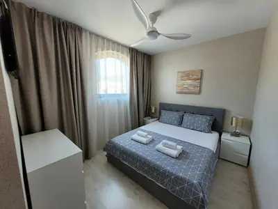 a bedroom with a bed with two pillows on it at Millenium II B34 in Sveti Vlas