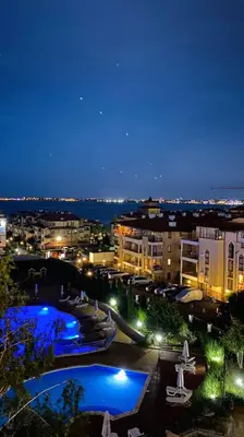a view of a city at night with two pools at Royal Palm 170 in Sveti Vlas