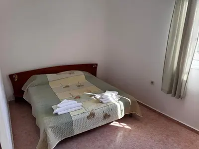 a small bed in a room with towels on it at Benadi Guest House in Burgas City