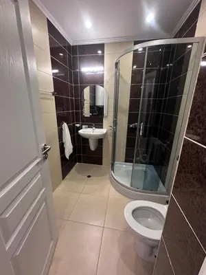 a bathroom with a shower and a toilet and a sink at Villa Tanita in Ravda