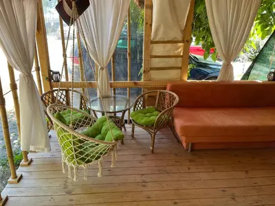 a living room with a couch and chairs and a table at Каравана Бамбоо in Sozopol