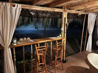 a bar in a room with two stools at Каравана Бамбоо in Sozopol