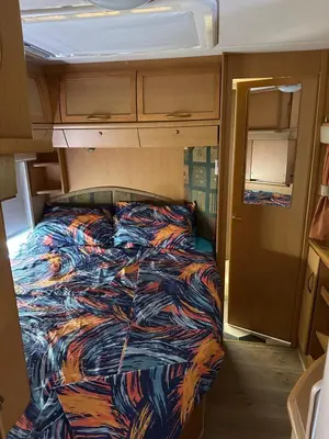 a bed in the middle of an rv at Каравана Бамбоо in Sozopol