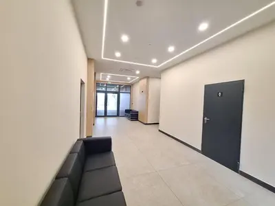 an empty hallway with a couch in a building at Sea Horizon in Burgas City
