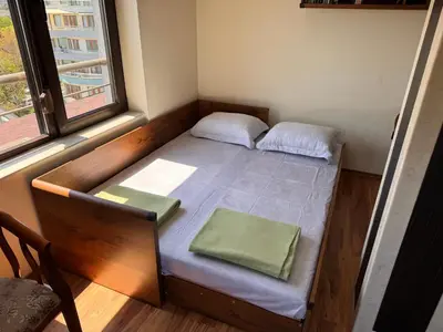a small bed in a room with a window at Sea View Escape in Burgas City
