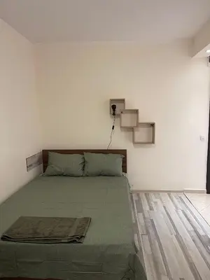 a bedroom with a bed in a white room at Mila 5 in Burgas City