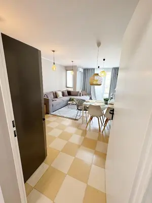 a living room with a couch and a table at Blue Home in Burgas City
