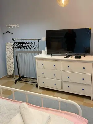 a bedroom with a dresser with a tv on it at Blue Home in Burgas City