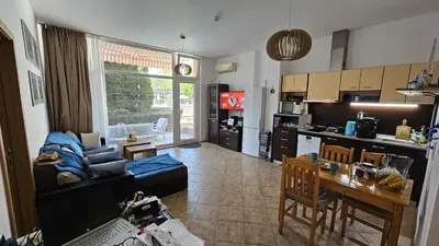 a kitchen and living room with a couch and a table at Grand Kamelia C1 in Sunny Beach