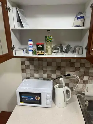 a microwave on a counter in a kitchen at Laguna 3 минуты до моря in Pomorie