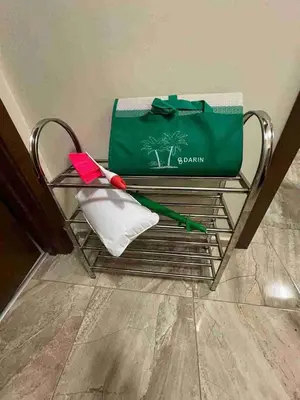 a green bag sitting on a metal bench with a bag at Laguna 3 минуты до моря in Pomorie
