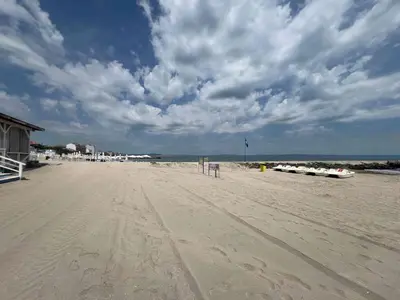 a view of a sandy beach with a cloudy sky at Laguna 3 минуты до моря in Pomorie
