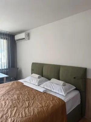 a bedroom with a large bed in a room at Sea Side in Burgas City