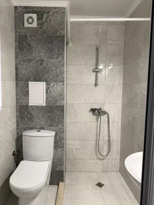a bathroom with a shower with a toilet and a sink at Sea Side in Burgas City