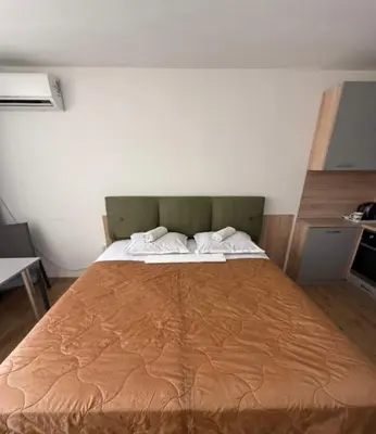 a bedroom with a large bed with two pillows at Sea Side in Burgas City