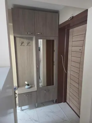 a bathroom with a large wooden cabinet with a mirror at Апартамент 9 -Рилска in Burgas City