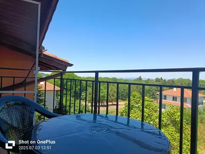 a table on the balcony of a house at Вила Фернандес in Chernomorets