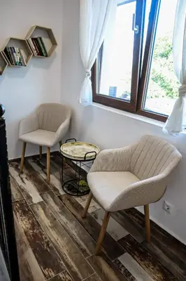 a living room with two chairs and a table at Конакъ Войнов in Yasna Polyana