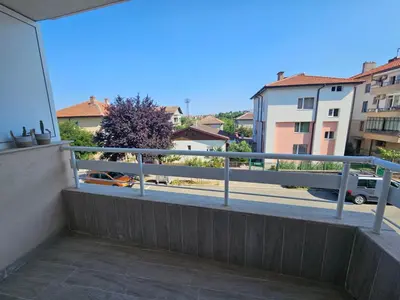 a balcony with a view of a street and buildings at Апартаменти Кастро2-Castro Apartments2 in Tsarevo