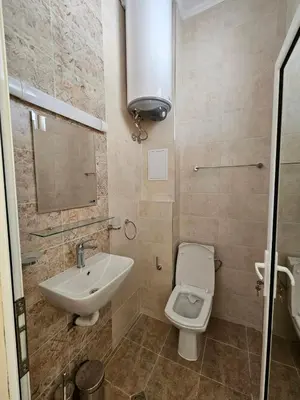 a bathroom with a sink and a toilet at Апартаменти Кастро2-Castro Apartments2 in Tsarevo