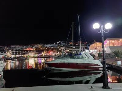 a boat is docked in a marina at night at Ela, Kedar 5 in Sveti Vlas